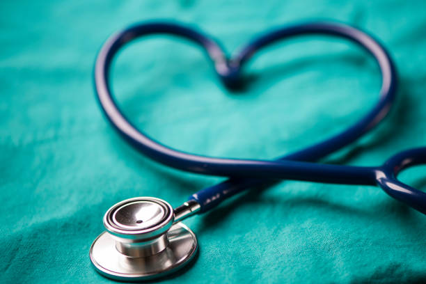 istock A stethoscope shaping a heart on a medical uniform, closeup 908006116