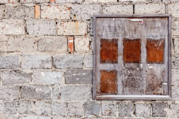 Old wooden board for the text against the background of an old brick wall. Mock - up