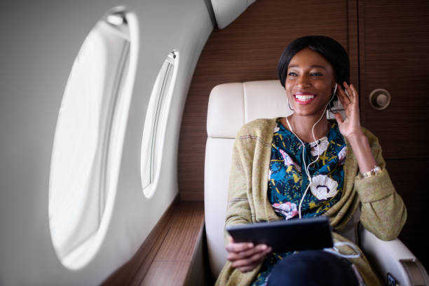 istock Woman in private jet airplane 908010186