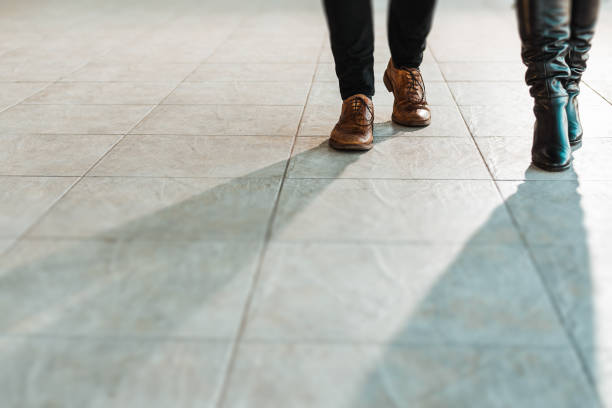 Low section of business people walking.