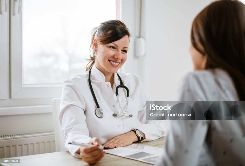 Smiling young doctor having a medical exam. Doctor Stock Photo
