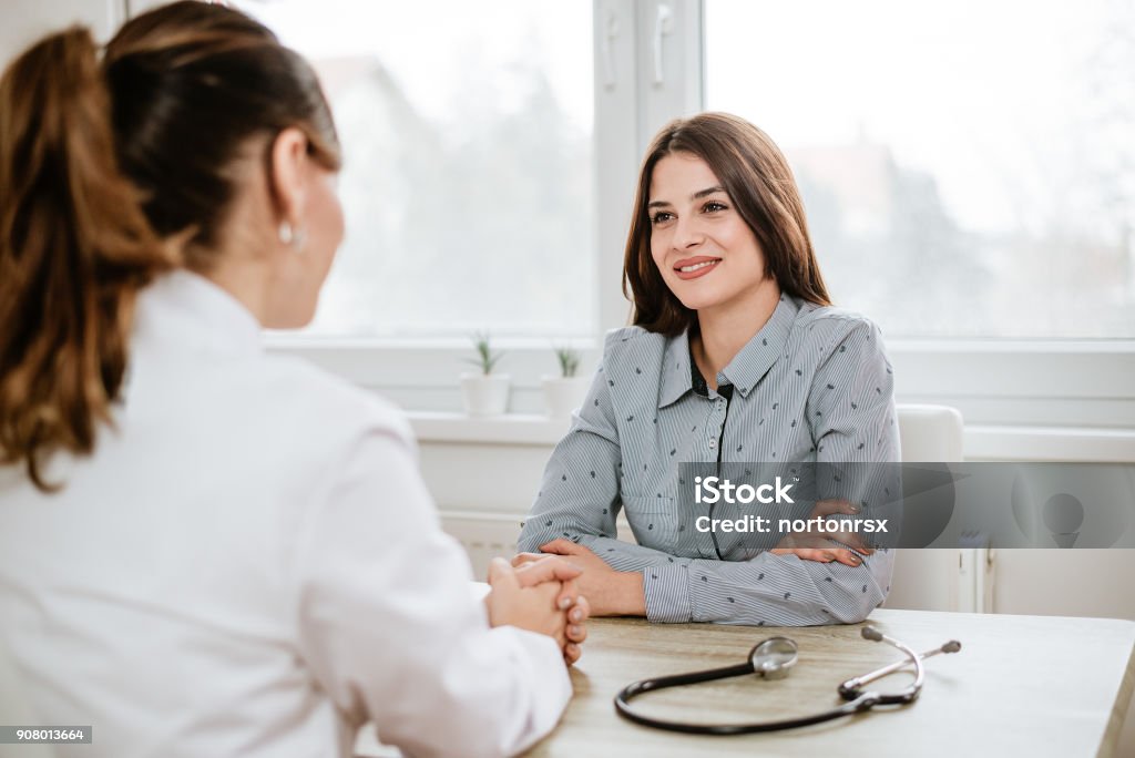 Young woman at doctor's office. Doctor Stock Photo