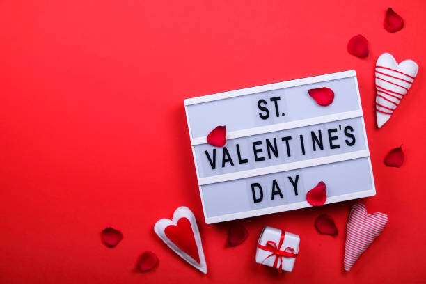 istock Happy valentines day / love symbols concept on bright red background 908018384