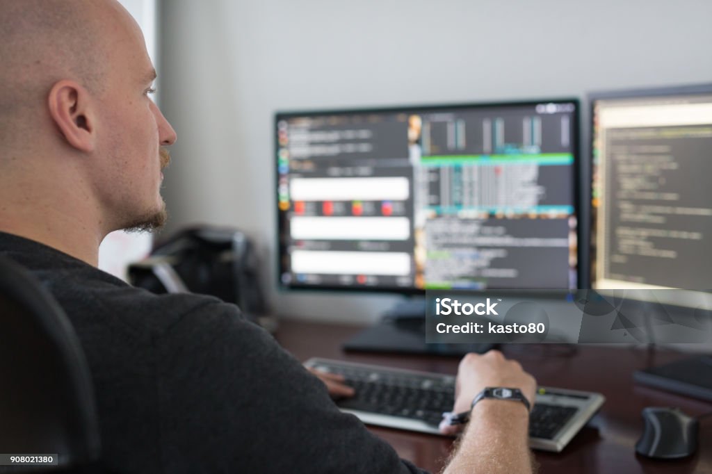 Man In Computer Programming Man Programming Code On Computers Screen At Desk Stock Photo - Download ...