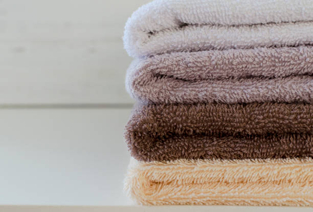 istock stack of towels on white wooden background 908022124