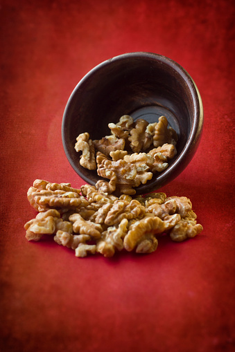 Cracked Walnuts on a Red textured background