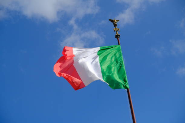 istock Italian flag fluttering against blue sky 908023036