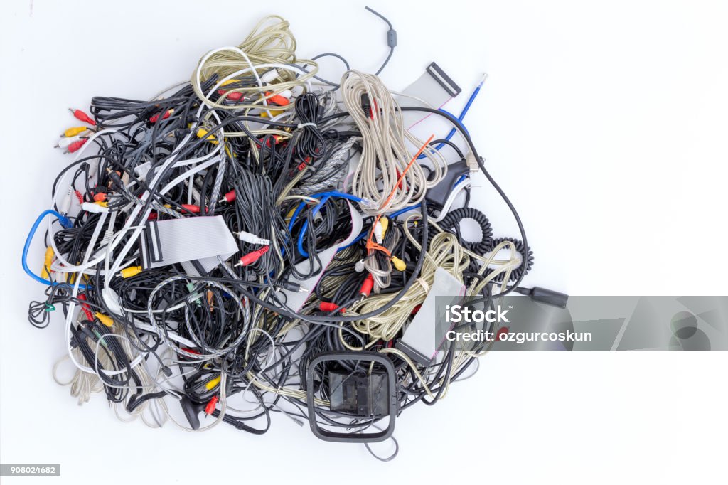 Jumbled pile of electrical cords and connectors Jumbled pile of old electrical cords and connectors for electronic devices awaiting discard viewed from above on white Cable Stock Photo