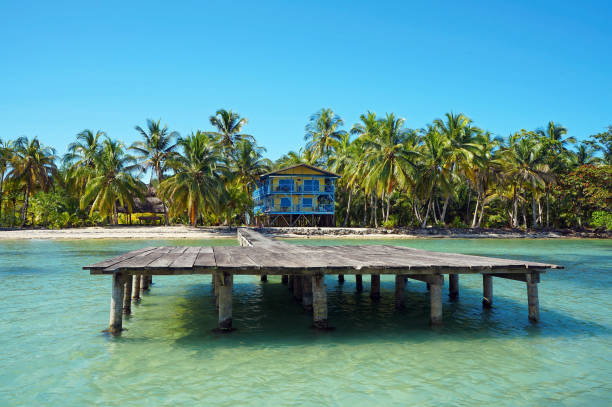 Tropical coastline with beach house and its dock, Caribbean sea