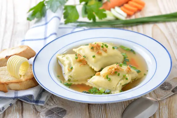 Vegetable broth with Swabian-style stuffed ravioli (so called 'Maultaschen') served with butter toast