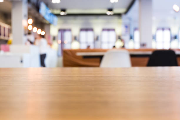 istock Wooden table in modern loft cafe. Abstract blurred restaurant backgroung with bokeh 908027488