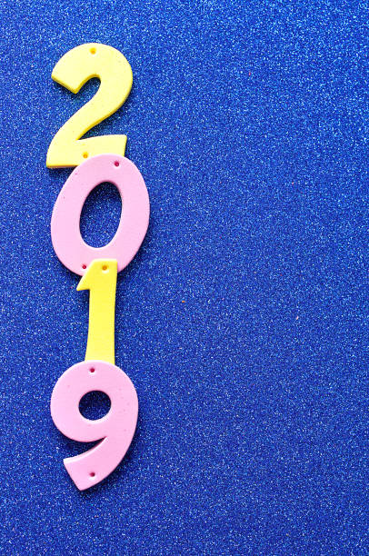 istock 2019 in pink and yellow numbers on a blue background 908027826