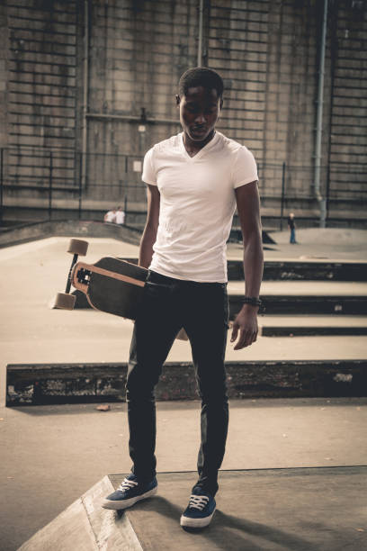 istock Man riding a longboard skateboard in New York City 908028238