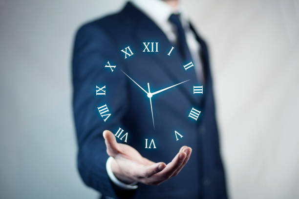 istock IreriBusinessman hand holding clock 908028248