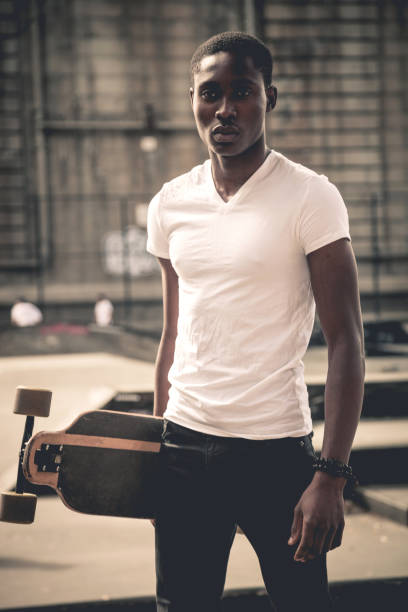 istock Man riding a longboard skateboard in New York City 908028390