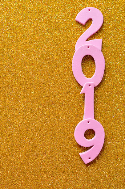 istock 2019 in pink numbers on a gold background 908028416