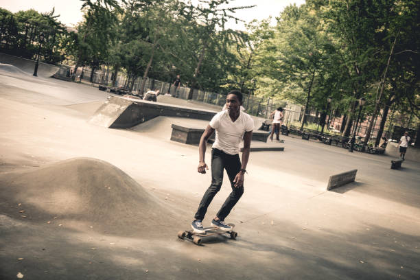 istock Man riding a longboard skateboard in New York City 908028648