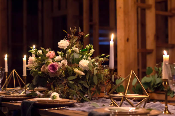 istock Decoration wedding table before a banquet in a wooden barn. 908029352