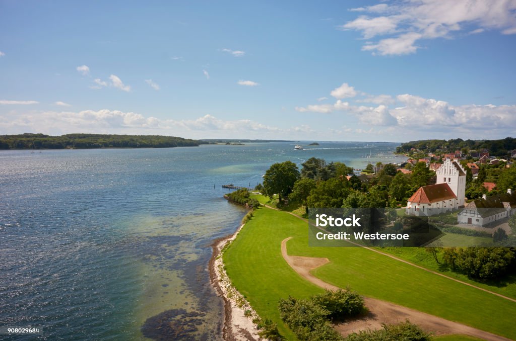 Ferry from Ærø to Svendborg High point view of Svendborgsund Svendborg August 06, 2017. Entry of ferry from Ærø a summer day. Aerial view from a bridge. Church placed near by the sea. Funen Stock Photo