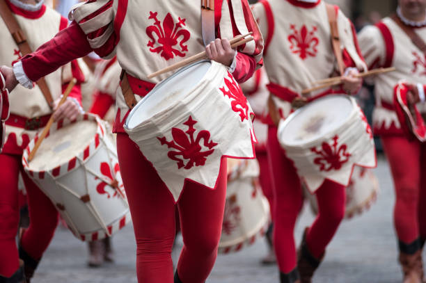A couple of drummers marching in a Christmas parade,