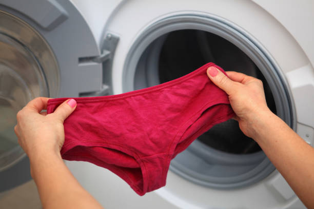 shorts in hands for laundry womens shorts in hands of woman who is going to do laundry it in washing machine washing period panties stock pictures, royalty-free photos & images