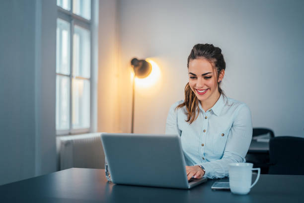 istock Woman sitting at her workplace in office and working by notebook. 908034144