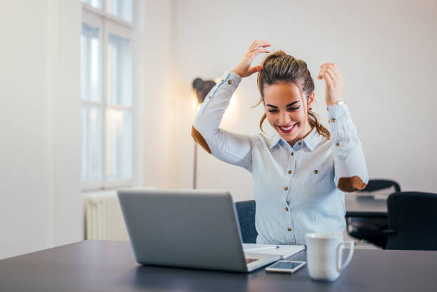 istock Cheerful young woman in modern office working. 908034148