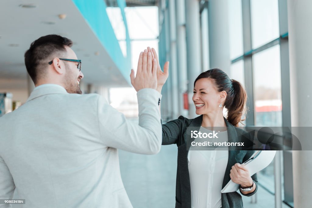 Two business people high-five. Job well done. High-Five Stock Photo