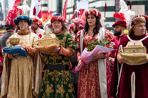 Florence, Tuscany: Three Wise Men and a Florentine noble woman, bringing gifts in precious golden caskets, during the historical recreation of the \