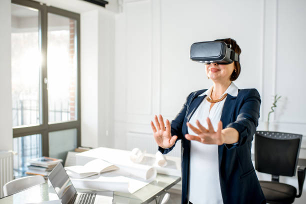 istock Senior woman using vr glasses to imagine or design a project 908035428