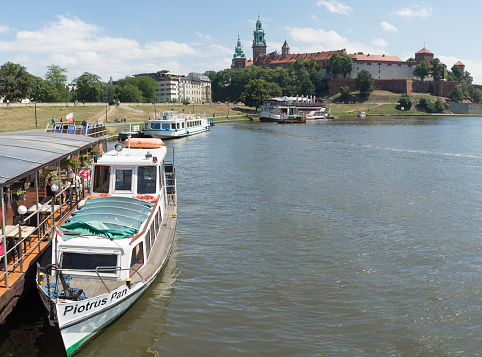 KRAKOW, POLAND - AUGUST 8, 2017: Boat on Vistula river. Visible tourist ship and undefined people