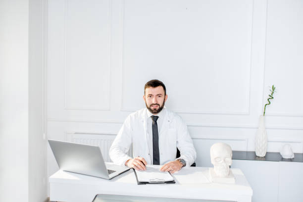 istock Male doctor working in the office 908038322
