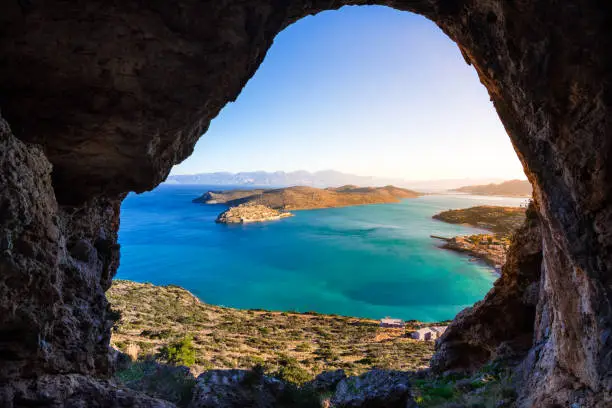 Panoramic view of the gulf of Mirambello with Spinalonga island. View from the mountain through a cave, Crete, Greece.