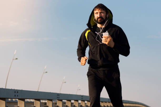 istock jogging bearded man with earphones 908039216