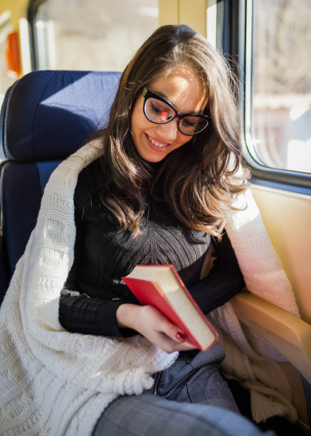 istock Young sad woman looking through the train window. 908039978
