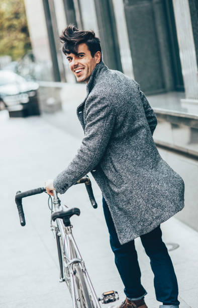 Man pushing his bicycle Man pushing his bicycle while walking around the city. top view on people walking and cyclists riding stock pictures, royalty-free photos & images
