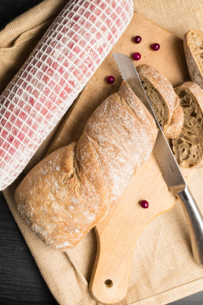 istock Ciabatta bread with salami and fresh cherry 908044248