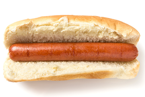 Assortment of unique hot dogs with a variety of toppings in sesame seed buns. Above view isolated on a white background.