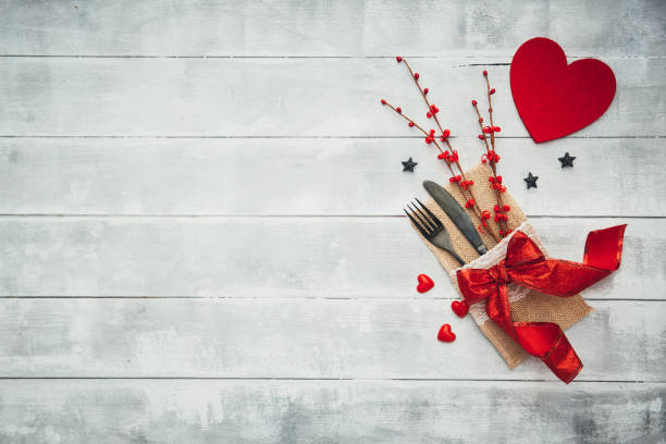 istock Fork, knife, napkin, heart. Celebrate valentine's day. Serving, Table decoration Valentine's Day, table set with a decorative heart. Image of dinner on Valentines day. Top view, copy space. 908044790