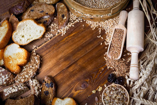 istock Assortment of baked bread on wooden table background 908045182