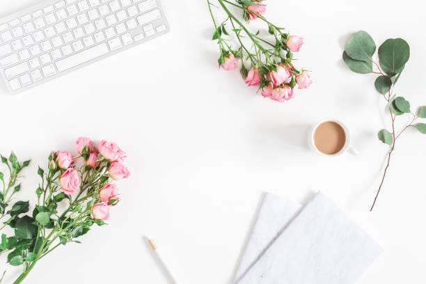 istock Desk with computer, rose flowers, eucalyptus. Flat lay, top view 908048004