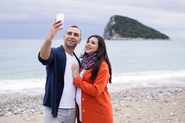 istock Selfie : Couple capturing fun moments on the beach 908048218