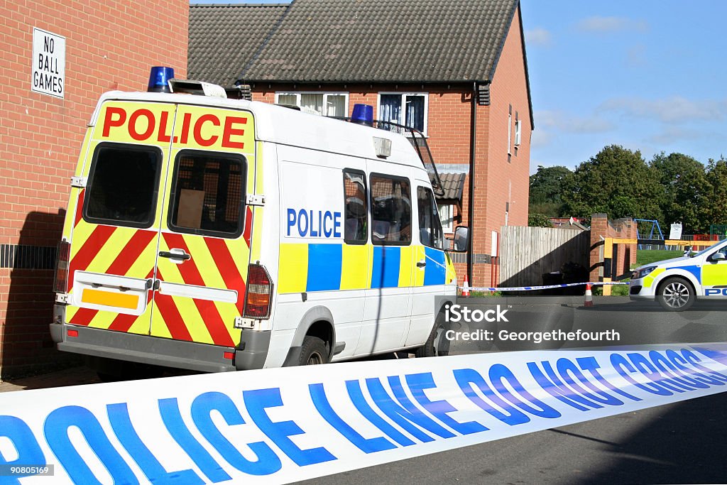 Close-up of crime scene tape with view of police van Cordoned crime scene featuring British police vehicles Police Force Stock Photo