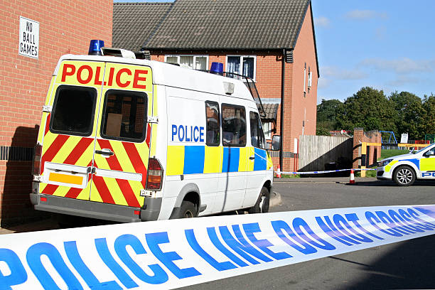 Close-up of crime scene tape with view of police van stock photo