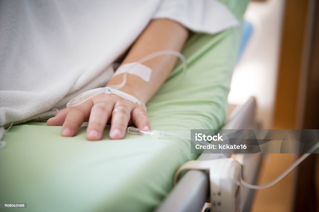 Focus patient's hand has get the saline solution syringe on it. Illness and treatment. Health insurance plan. Focus patient's hand has get the saline solution syringe on it. Illness and treatment. Health insurance plan. Reimbursement and Medical expenses. image for illustration, copy space, article. Hospital Stock Photo