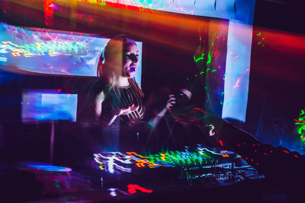 istock Woman DJ Mixing Music on Stage 908063596
