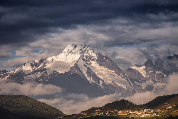 Landscape of China Yunnan Meili Snow Mountain, small village with the snow mountain background in morning. Landscape of China Yunnan Meili Snow Mountain, small village with the snow mountain background in morning. meili mountains photos stock pictures, royalty-free photos & images