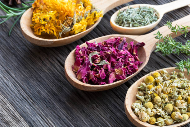 istock Herbs on spoons on a wooden background with copy space 908067046