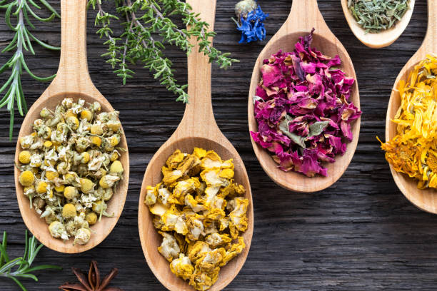 istock Herbs on spoons on a wooden background, top view 908067064