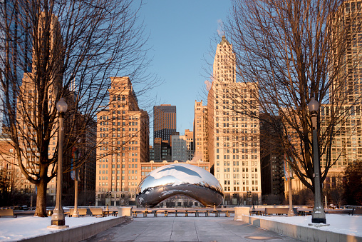Chicago, USA - January 17, 2018: Cloud Gate is a public sculpture by Indian-born British artist Sir Anish Kapoor, that is the centerpiece of AT&T Plaza at Millennium Park in the Loop community area of Chicago, Illinois. The design was inspired by liquid mercury and the sculpture's surface reflects and distorts the city's skyline